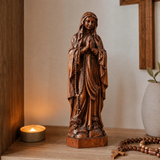 Wooden statue of Our Lady of Lourdes praying