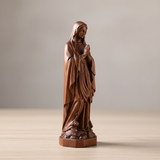 Wooden statue of Our Lady of Lourdes praying