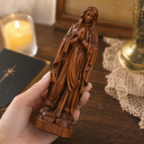 Wooden statue of Our Lady of Lourdes praying