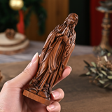 Wooden statue of Our Lady of Lourdes praying