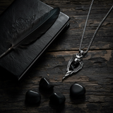 Dark wood flat lay black feather stones
