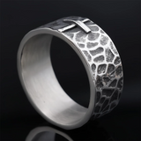 Hand-carved stone cross ring carries His gentle protection