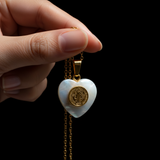 Female hand dangling - black background pearl glow