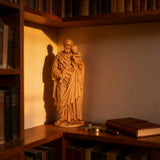 Beechwood roundel of Joseph holding a child: sacred heritage, warmth and eternity