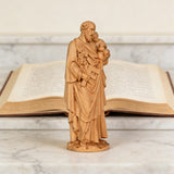 Beechwood roundel of Joseph holding a child: sacred heritage, warmth and eternity