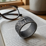 Hand-carved stone cross ring carries His gentle protection