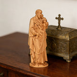 Beechwood roundel of Joseph holding a child: sacred heritage, warmth and eternity