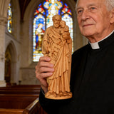 Beechwood roundel of Joseph holding a child: sacred heritage, warmth and eternity