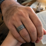 Hand-carved stone cross ring carries His gentle protection