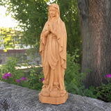 Round carving of Our Lady of Lourdes in beech wood: Sacred beauty, handcrafted technique
