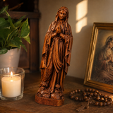 Wooden statue of Our Lady of Lourdes praying