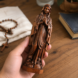 Wooden statue of Our Lady of Lourdes praying