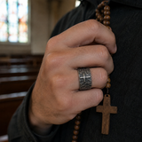 Hand-carved stone cross ring carries His gentle protection