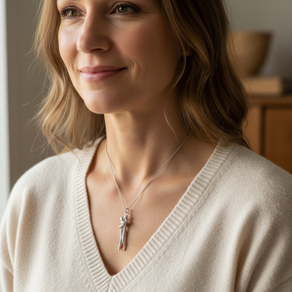 Hands holding the necklace, suggesting the preciousness of the gift