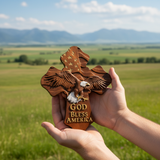 Hands holding cross in countryside