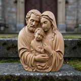 Holy Family beechwood carving close-up on mossy church stone step in natural morning light