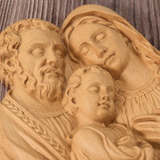 Close-up detail of hand-carved Holy Family beechwood sculpture showing chisel marks and wood grain