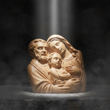 Holy Family beechwood sculpture with dramatic divine light beam on dark stone surface