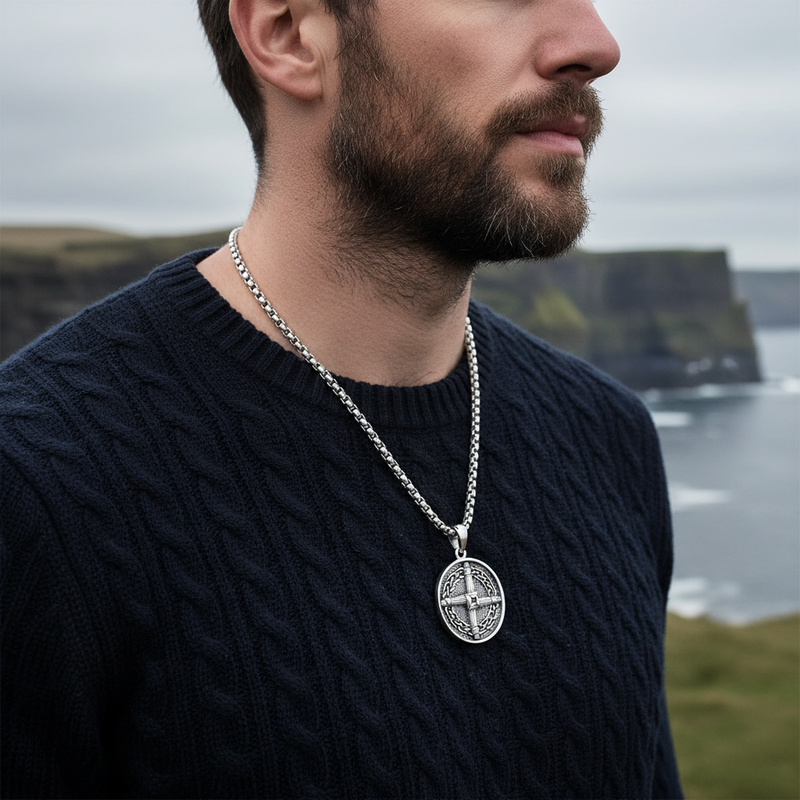 Man wearing Celtic cross knot necklace with navy sweater